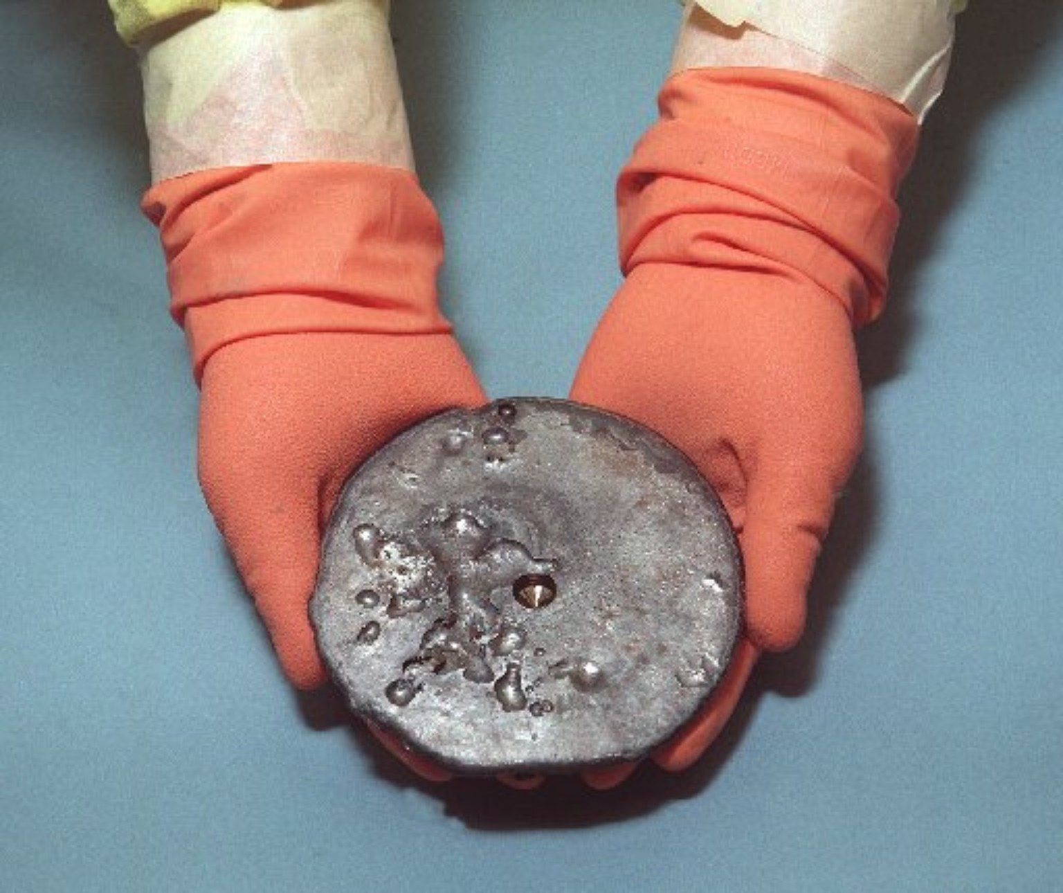 Antique object held for inspection
